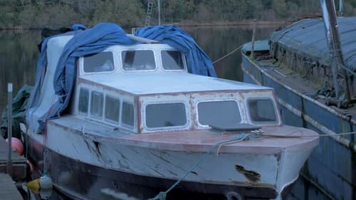 Weathered Boat Moored in River on Overcast Day