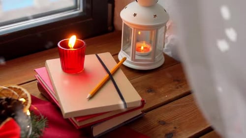 Festive Christmas Composition with Candles, Books and Snow