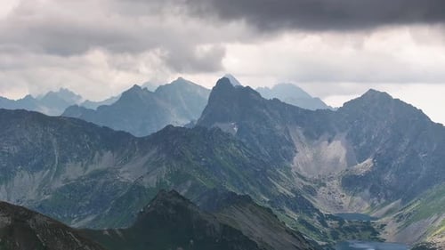 Discover breathtaking mountain landscapes under swirling clouds at dusk