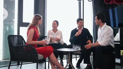 Diverse professionals in an informal business discussion or client meeting at restaurant.