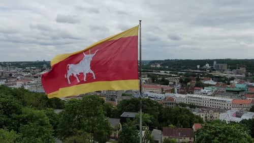 City Landscape with Red and Yellow Flag Waving