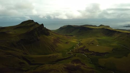 Aerial landscape view of a river flowing in a mountain valley, in Iceland