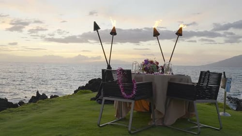 A romantic table set for two at sunset on the island of Maui, Hawaii