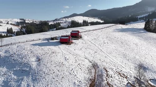 Aerial View Modern Red Cabins in Snowy Mountains Cozy Getaway in Winter Landscape with Panoramic