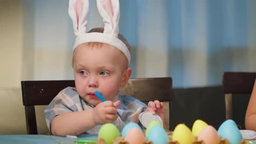 Baby Boy Paints Colorful Eggs Children Color and Decorate an Easter Egg