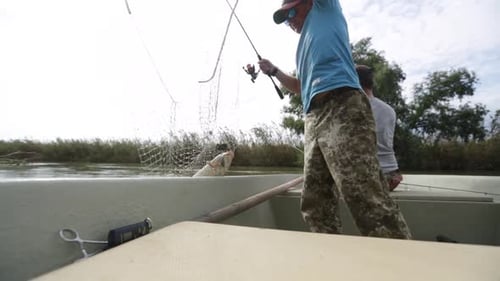 Men Fishing from a Boat on a River