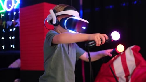 Boy Plays Video Game With VR Headset