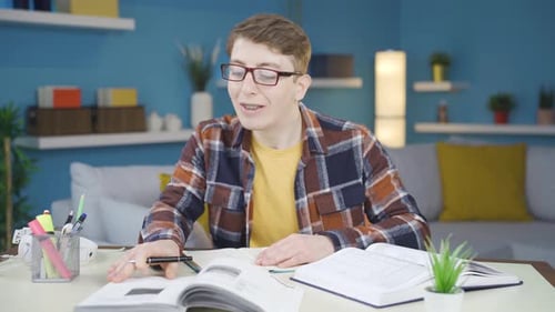 Young Adult Studying at Home with Books