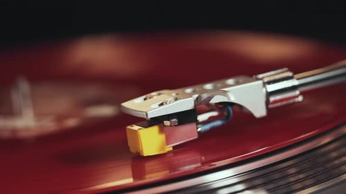 Vinyl Retro player turntable. Rotating red vinyl plate close-up.