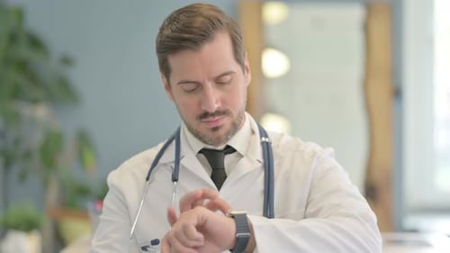 Portrait of Male Doctor Using Smart watch