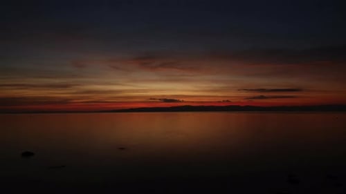 Romantic orange sunset by the sea. 4k. Time lapse. Wide angle