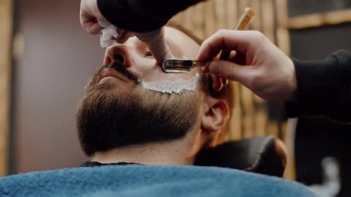 Man Getting Shave at the Barber Shop