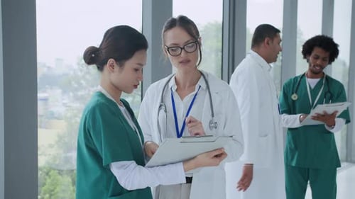 Medical Coworkers Planning Work at Hall of Clinic