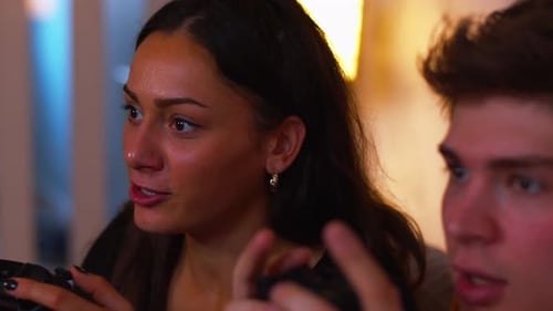 Young Adults Playing Video Games and Laughing