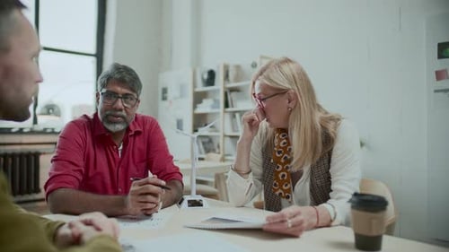 Colleagues Meeting About Renewable Energy in Office