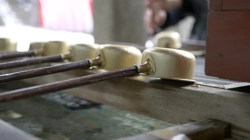 Golden ladles adorn the sacred basin Omizuya, Water Purification Building Toshogu Temple