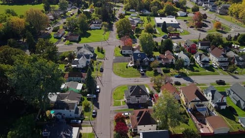 Aerial View of American Suburban Neighborhood with Residential Houses Intersecting Streets Green