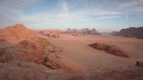 Vast Desert Landscape at Sunrise with Towering Rock Formations