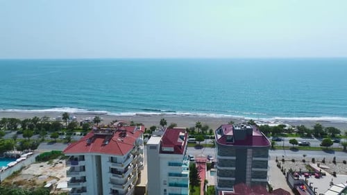 Aerial View Residential Complex With Stunning Azure Pool and Kids' Water Slides By the Sea