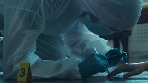 Crime Scene Investigator Examines Evidence With Magnifying Glass