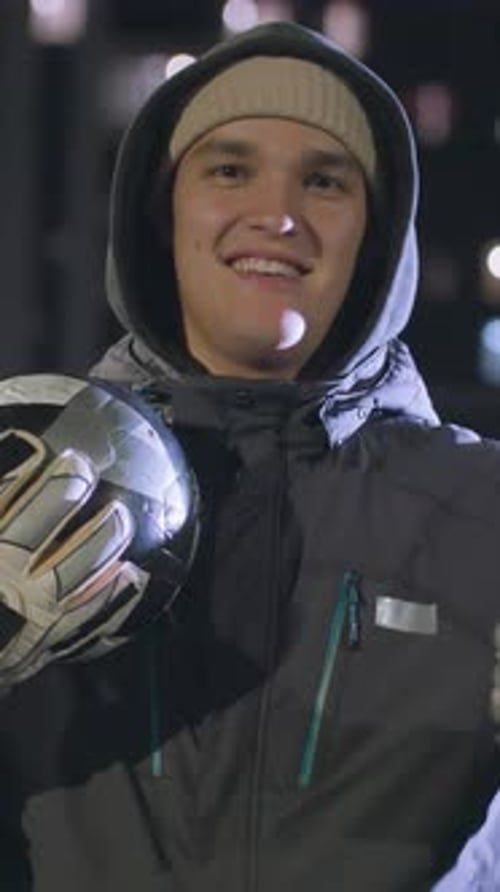 Smiling Goalie with Soccer Helmet in City at Night