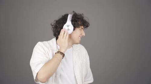 Happy young man listening to music.