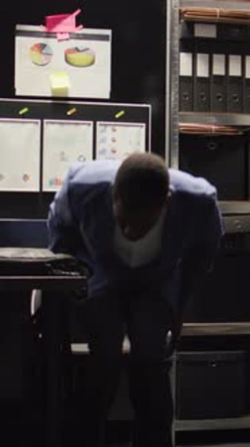 Young Man Working on Laptop at Desk