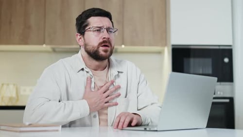 Brunette Man Placing Hand on Chest While Having Heart Attack During Workday