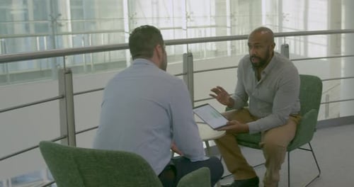 Corporate Business Meeting in Office Lobby using Digital tablet Computer