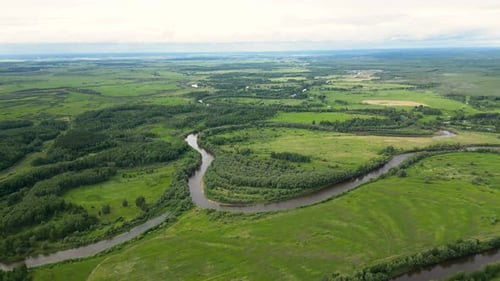 Beautiful Green Summer Nature Landscape with River and Meadows Aerial View Drone Shot