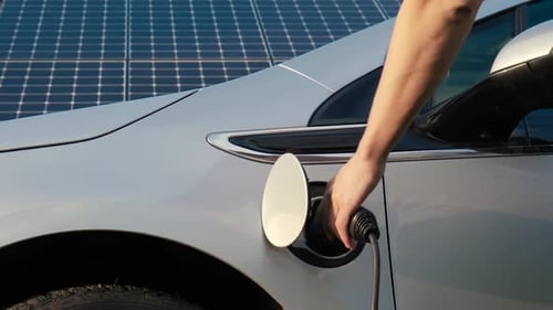 Electric Car Unplugged with Solar Panels Background