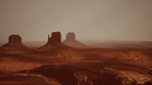 A Panoramic Desert Landscape with Two Prominent Rock Formations in the Distance