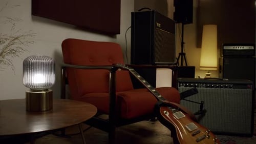 Vintage music studio with electric guitar, amplifiers, and warm ambient lighting
