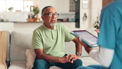 Senior Man on Couch With Healthcare Worker
