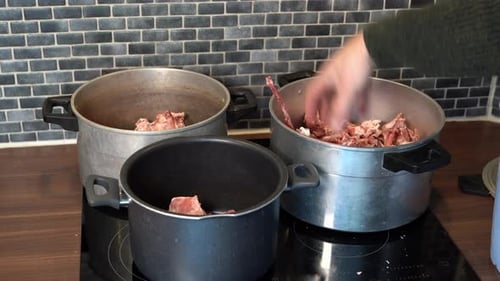 Raw Meat and Bones Transferred Between Silver Pots