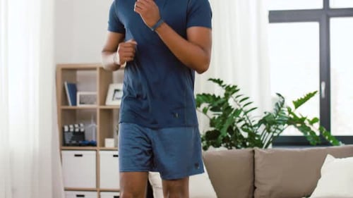 Man Exercising at Home Doing High Knees