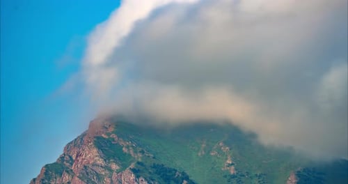 Timelapse of Clouds Over a Mountain Peak