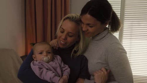 Loving Couple with Infant in Warm Home Interior