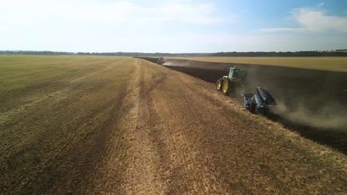 Tractors plowing the field in Ukraine