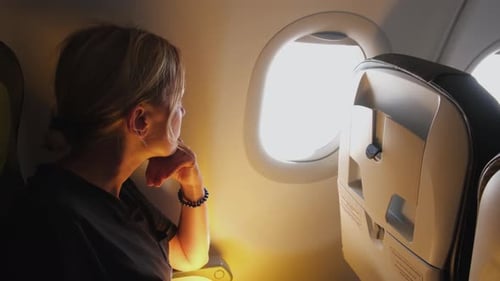 Woman Looking out of the Airplane Window