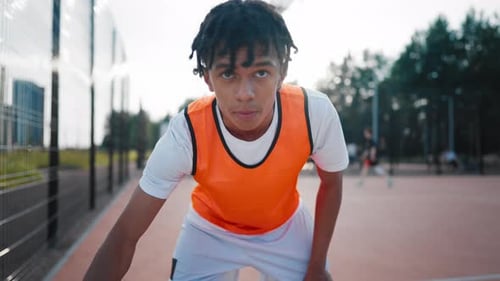 Motivated Young Streetballer Playing with Ball on Open Court Medium Portrait Active Sport and
