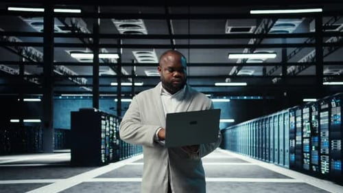 Data Center Computer Scientist Using Laptop to Manage System Stability