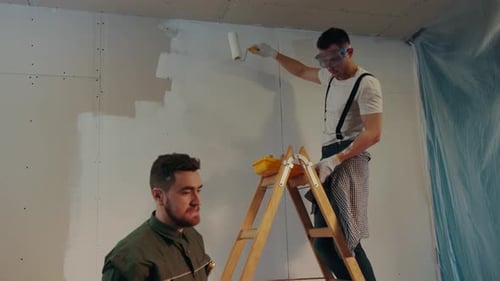 NEW YORK April 5 2017 One of the Skilled Builders Puts the Painting Trail on the Ladder Assisting to