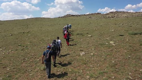 Aerial View Of A Group Of Hikers Climbing The Hill