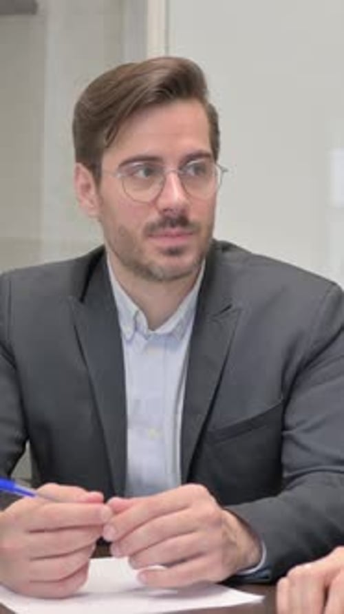 Happy Colleagues Talking while Sitting in Office, vertical video