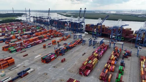 Container Ship Moored in Port with Trucks and Cranes Top View of Containers Carrying Cargo and