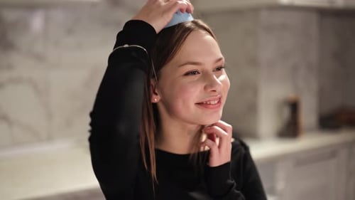 Woman Puts on Party Hat Indoors
