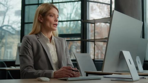Professional Woman Communicating at Desk with Computer