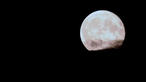 Full Moon Partially Obscured by Clouds at Night
