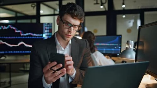 Stock Trader Holding Smartphone Work in Office Focused Man Professional Check